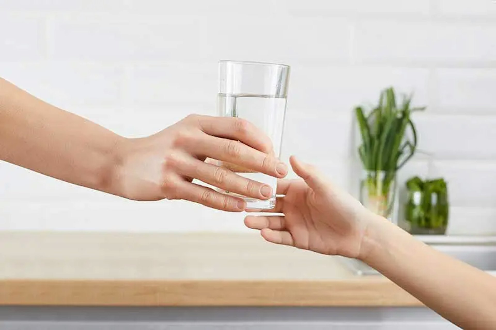 women-handing-water-to-child